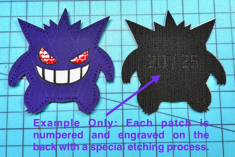 May include: Two embroidered patches in the shape of a cartoon ghost. One patch is purple with red and white details, the other is black. The patches are on a blue grid background. The text on the image says "Example Only: Each patch is numbered and engraved on the back with a special etching process."