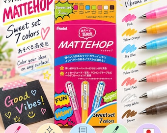 May include: A Pentel Mattehop Sweet set of 7 gel ink pens with 1.0mm ballpoints. The packaging is bright pink and yellow, displaying the ink colors: pink, yellow orange, sky blue, yellow green, coral pink, ivory white, and brown.