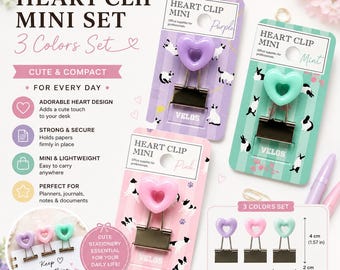 May include: A set of three heart-shaped binder clips in purple, pink, and mint green on individual display cards. Each clip features a metallic base and a heart topper. A diagram shows the clips measure 4 cm by 2 cm, or 1.57 inches by 0.79 inches.