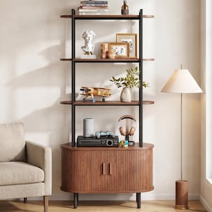 May include: A modern wooden bookshelf with black metal supports. The shelves display decorative items like a bust, framed pictures, a model airplane, and books. A floor lamp and armchair are nearby.
