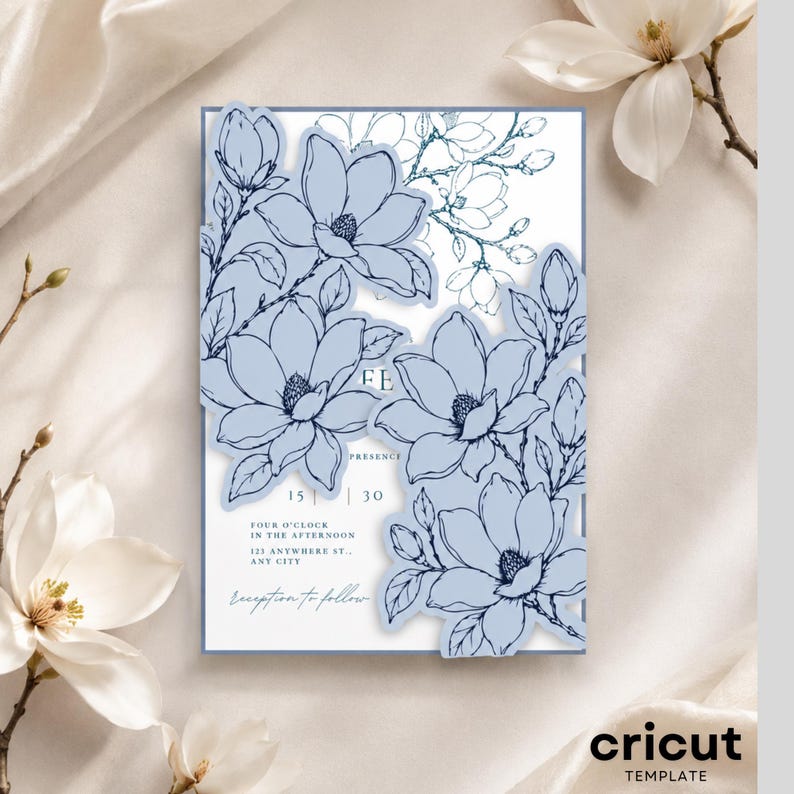 May include: A rectangular wedding invitation card featuring die-cut edges with light blue magnolia flower illustrations. The white card includes printed text: YOUR PRESENCE, 15 | 30, FOUR O'CLOCK IN THE AFTERNOON, 123 ANYWHERE ST., ANY CITY, and reception to follow.