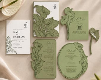 May include: A wedding stationery set featuring white and sage green cards with black line art of anthurium flowers. The set includes an invitation, RSVP card with a QR code, menu, and details card, all displaying elegant typography and floral motifs.