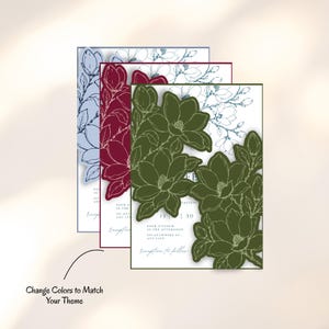 May include: Three rectangular wedding invitation cards featuring die-cut magnolia flower edges. The cards are layered in blue, burgundy, and olive green, each displaying white space with printed text and the phrase Change Colors to Match Your Theme.