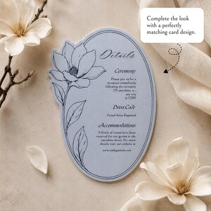 May include: An oval-shaped light blue card with a dark blue line drawing of a magnolia flower on the left side. The text reads Details, Ceremony, Dress Code, and Accommodations, with placeholder information and a website address included.