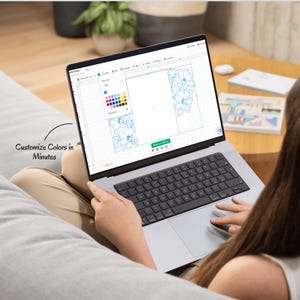 May include: A silver laptop displaying a design software interface with a floral graphic and a color selection menu. The screen shows a grid layout with blue flower outlines and text that reads Customize Colors in Minutes on the side.