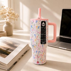 Puede incluir: Un vaso con estampado floral con asa y tapa rosas, con pajita. El vaso tiene una base blanca con un dise&ntilde;o de flores silvestres de colores. El asa y la tapa son de color rosa claro a juego. Capacidad: 1,18 litros.