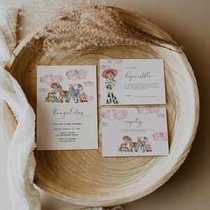 May include: A set of baby shower invitations with a watercolor illustration of a cowgirl and other characters. The invitations include the text "It's a girl story" and details for the event. The design is set on a wooden tray.