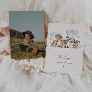 May include: Two cards on a white surface. One card features a photo of a child in a cowboy hat. The other card has a watercolour illustration of Toy Story characters with the words "Thank you" and "You've got a friend in me."