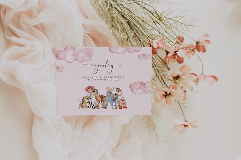 May include: A baby shower registry card with a pink background and watercolor illustrations of Toy Story characters. The word "registry" is written in cursive, with the text "The mom to be is registered at Baby Shower Boutique" below.