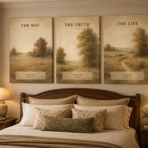 May include: Three framed landscape art pieces with the words "The Way", "The Truth", and "The Life". Each piece features a field with trees and a quote from the Bible. The art hangs above a bed with a wooden headboard.