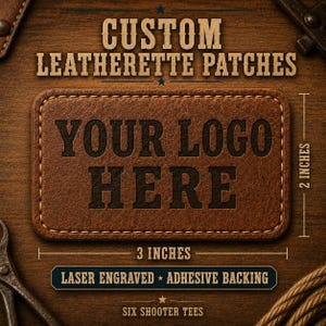 May include: A rectangular brown leatherette patch with stitched edges, featuring the laser-engraved text 'YOUR LOGO HERE'. The patch measures 3 inches by 2 inches and includes an adhesive backing. The text 'CUSTOM LEATHERETTE PATCHES' appears above.
