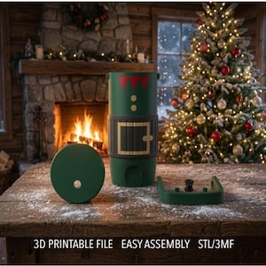 May include: A green cylindrical container with a black belt graphic, red triangular collar accents, and two yellow buttons. The set includes a circular lid with a center hole and a U-shaped base component. Text reads: 3D PRINTABLE FILE EASY ASSEMBLY STL/3MF.