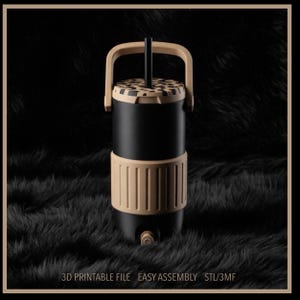 May include: A black and tan water cooler with a handle and a spigot. The cooler has a cylindrical shape with a tan band around the middle and a patterned lid. The text "3D PRINTABLE FILE EASY ASSEMBLY STL/3MF" is at the bottom.