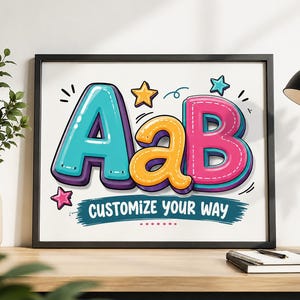 May include: A framed wall art print featuring the letters AaB in a bold, colourful, cartoon-style font. The letter A is teal, the lowercase a is yellow, and the B is pink. Below the letters, the text CUSTOMIZE YOUR WAY is printed in white.