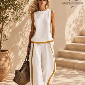 May include: A sleeveless white top and matching wide-leg trousers featuring mustard yellow side panels. The outfit is paired with a dark brown textured tote bag and brown sandals. The logo for weaveChronicles is visible in the upper right corner.