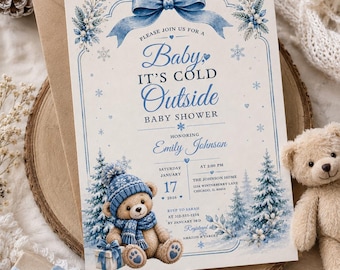 Könnte beinhalten: Eine rechteckige Einladungskarte für eine Babyparty mit einer blauen Schleife, Schneeflocken und einem Teddybären mit blauem Mützchen und Schal. Der Text lautet: Please join us for a Baby, It's Cold Outside baby shower honoring Emily Johnson.