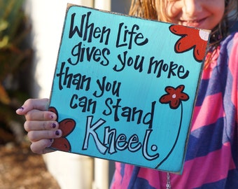 when life gives you more than you can stand kneel  wood sign card