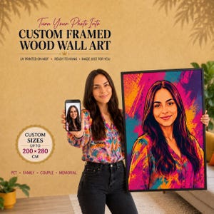 Könnte beinhalten: Ein individuell gerahmtes Wandbild aus Holz mit einem lebendigen, farbenfrohen Porträt einer Person mit langem dunklen Haar. Das Kunstwerk befindet sich in einem schwarzen Rahmen. Der Text lautet: Turn Your Photo Into CUSTOM FRAMED WOOD WALL ART.