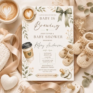 May include: A rectangular baby shower invitation card featuring watercolour illustrations of a coffee cup, a latte, a green bow, and baby booties. The text reads: A little one is on the way, Baby is Brewing, Join us for a baby shower honouring Kelsey Anderson.