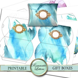 May include: Printable gift box templates featuring a watercolor design with blue and green hues. The boxes have a decorative gold frame with a blank circle in the center. The text "Printable" and "Gift Boxes" is at the bottom of the image.