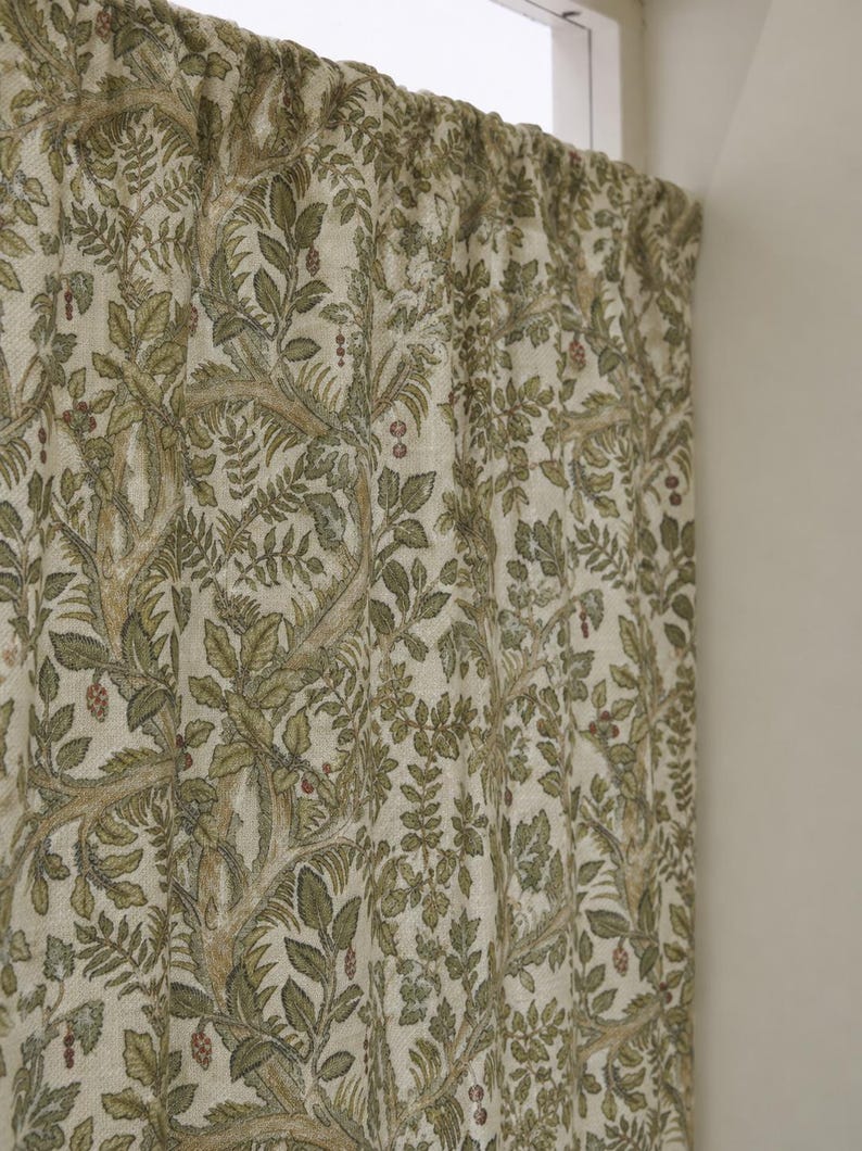 May include: A curtain panel featuring an off-white base fabric with a dense, repeating botanical pattern in shades of olive green, sage, and muted brown. The design depicts intricate tree branches, detailed leaves, and small berry clusters.