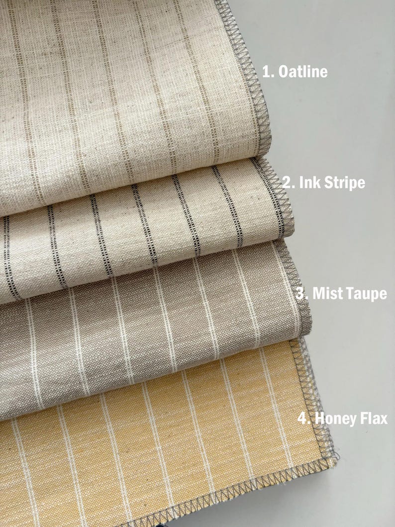May include: Four fabric swatches with vertical stripe patterns. The swatches are labeled: 1. Oatline, 2. Ink Stripe, 3. Mist Taupe, and 4. Honey Flax. The fabrics have a textured appearance and are in neutral tones of beige, gray, and yellow.