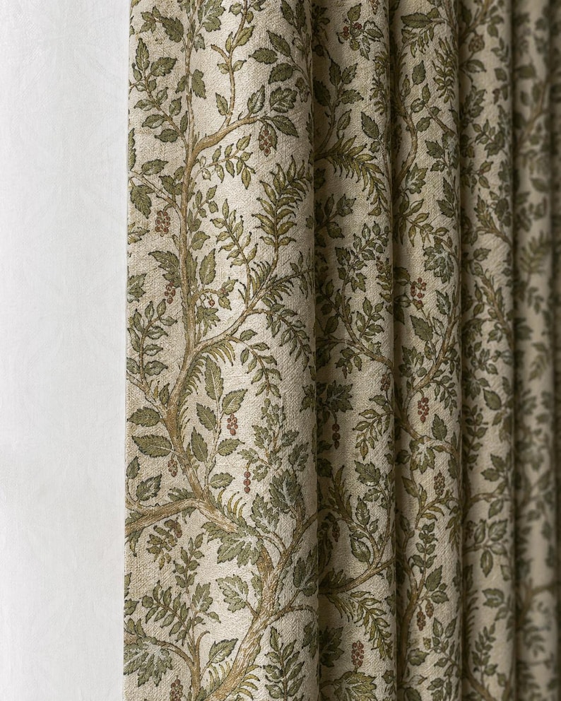 May include: A pleated curtain panel featuring a light beige background with a repeating botanical pattern of brown tree branches, green leaves, and small clusters of red berries. The fabric has a textured appearance with vertical folds.