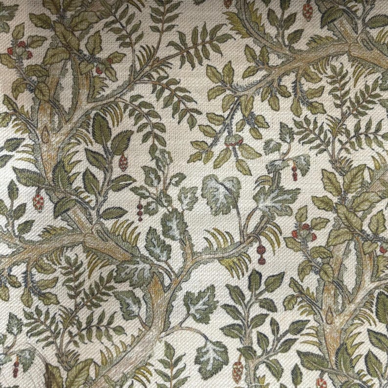 May include: A woven fabric featuring a dense botanical pattern of intertwining tree branches, textured leaves in shades of olive and sage green, and small red berries set against a light cream-colored background with a visible textile weave.