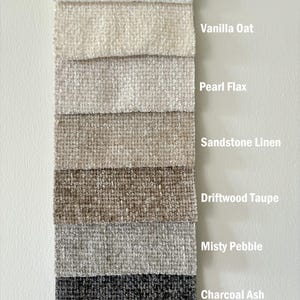 May include: A vertical display of seven fabric swatches with a textured weave, labelled with the text Multiple Colours Available and colour names: Snow Boucle, Vanilla Oat, Pearl Flax, Sandstone Linen, Driftwood Taupe, Misty Pebble, and Charcoal Ash.