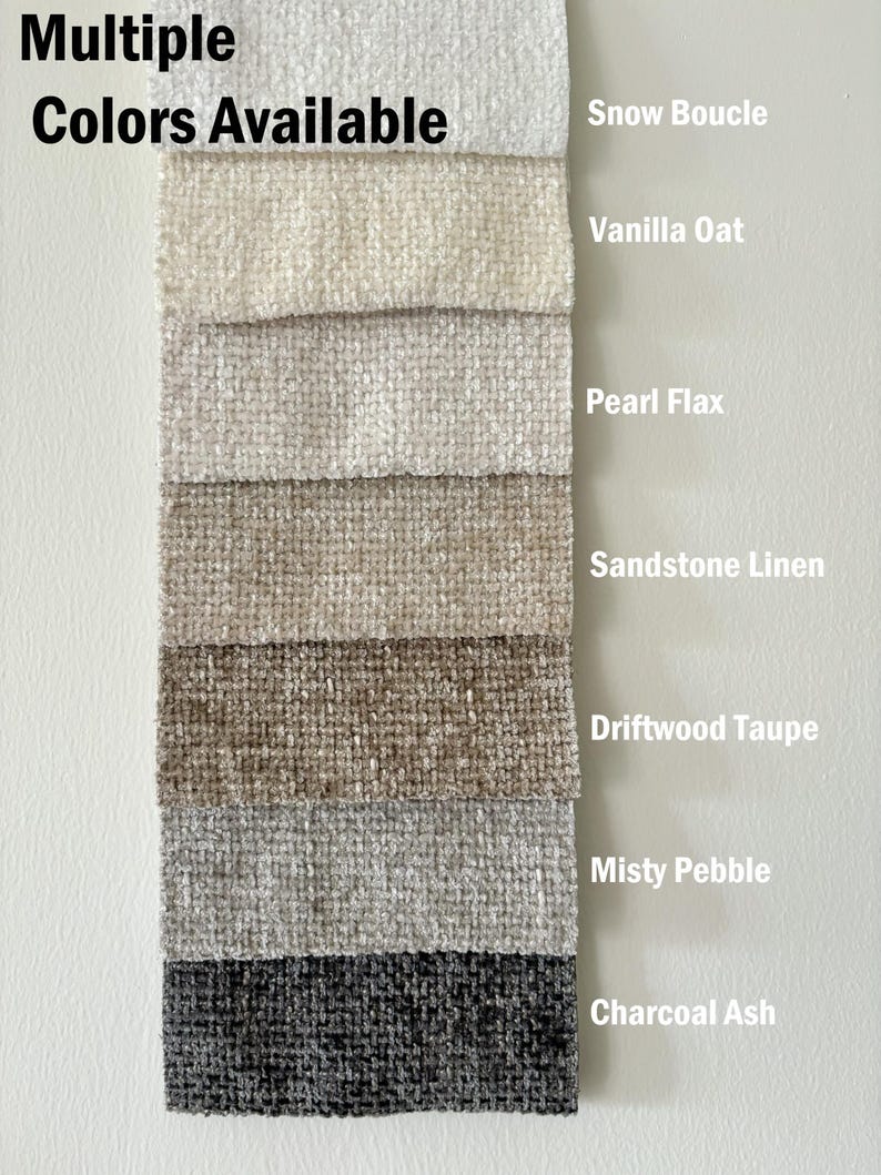 May include: A vertical fabric swatch display labeled Multiple Colors Available, featuring seven textured boucl&eacute; fabric samples in shades of Snow Boucle, Vanilla Oat, Pearl Flax, Sandstone Linen, Driftwood Taupe, Misty Pebble, and Charcoal Ash.