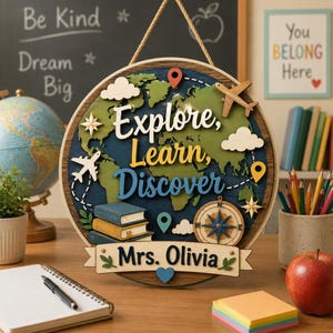 May include: A round wooden sign with a world map design. The sign features the words "Explore, Learn, Discover" and "Mrs. Olivia." Decorative elements include airplanes, clouds, a compass, and books. The sign is hanging by a rope.