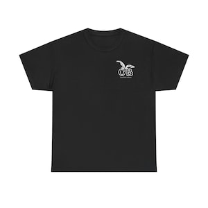 May include: Black t-shirt with a white logo on the upper left chest. The logo features the letters "OB" with a stylized bird design above. The shirt is made of a soft material and has a crew neck.