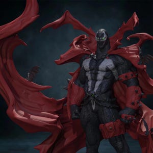 May include: A Spawn action figure featuring a black textured suit with white chest markings, green eyes, and a large, flowing red cape. The figure includes red spiked gauntlets, a red utility pouch on the thigh, and a silver chain belt with a skull detail.