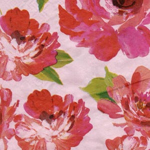 May include: A rectangular paper napkin featuring a floral pattern with large, painterly red and pink roses set against a light pink background, accented by green leaves. The text FOLDED - SINGLE PANEL is printed in black at the bottom.