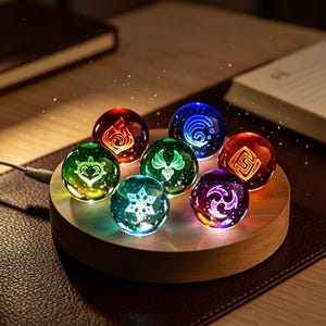 May include: Seven illuminated glass spheres, each with a unique symbol and colour. The spheres sit on a wooden base, connected by a charging cable. Colours include red, blue, green, orange, purple, and clear. The symbols are white and glow.