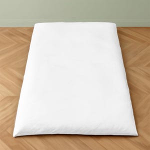 May include: A rectangular white duvet cover featuring a smooth, solid-colored fabric surface. The bedding item is laid out flat, displaying a clean, minimalist appearance with no visible patterns, textures, or additional decorative elements.
