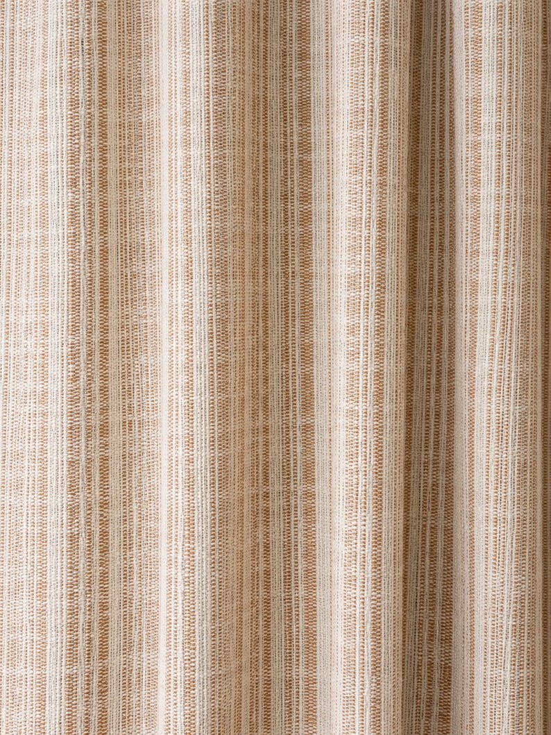 May include: A fabric curtain featuring a vertical striped pattern in shades of tan, beige, and white. The material has a visible woven texture with alternating thin and thick lines running vertically across the entire surface of the textile.