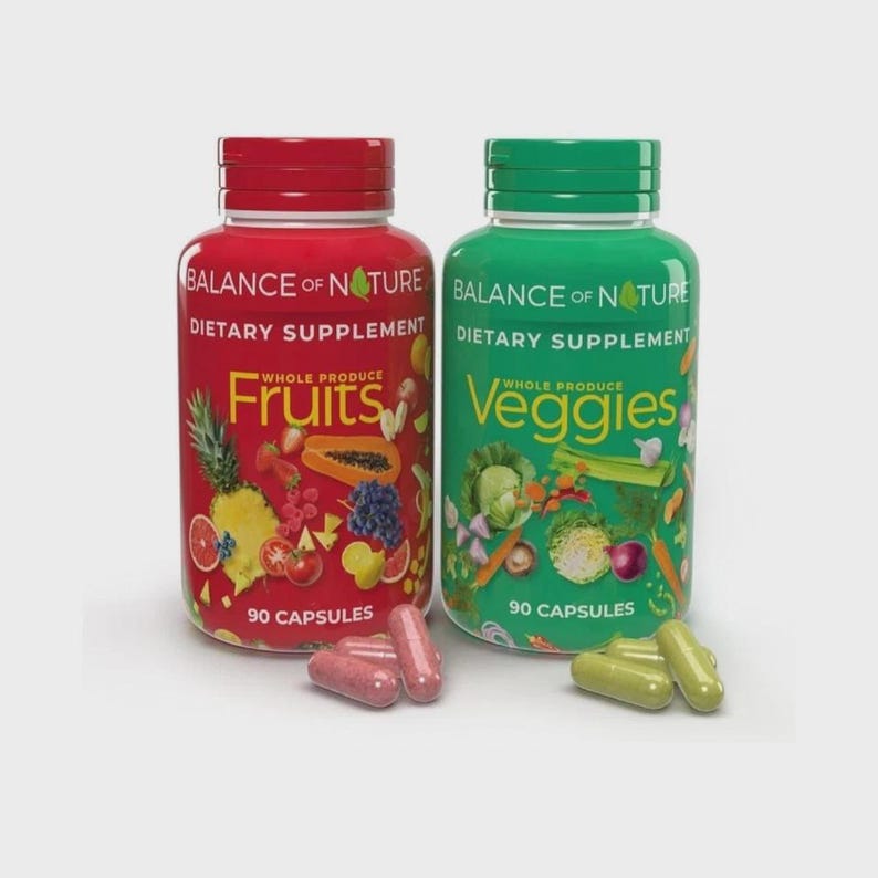 May include: Two supplement bottles, one red and one green, labelled "Balance of Nature" and "Dietary Supplement." The red bottle says "Fruits" and the green bottle says "Veggies." Each bottle contains 90 capsules. Capsules are visible in front of the bottles.