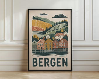 May include: A framed wall art print featuring a stylised illustration of Bergen, Norway. The image depicts colourful wooden houses along a waterfront, rolling green hills, and dark clouds against a cream background. The word BERGEN is printed in bold.