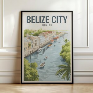 May include: A framed travel poster featuring a coastal scene in Belize City, Belize. The illustration depicts a waterway lined with buildings, palm trees, and small boats floating on the water. The text BELIZE CITY and BELIZE is printed at the top.