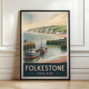 May include: A framed travel poster featuring a coastal scene of Folkestone, England. The illustration depicts two fishing boats docked in a harbour with white cliffs and green hills in the background. The text Folkestone England is printed at the bottom.