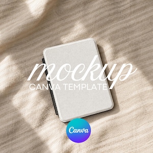 May include: A white rectangular object with a textured surface, possibly an e-reader or tablet, is displayed on a beige fabric. The word "mockup" is written in cursive across the top, with "CANVA TEMPLATE" below. A Canva logo is in the bottom right.