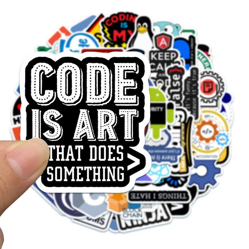 May include: A collection of assorted vinyl stickers featuring various programming and technology-themed graphics. The top sticker displays the white text "CODE IS ART THAT DOES SOMETHING" on a black background with a white border and a closing bracket.