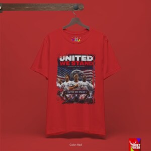 Lifestyle photograph of the USA soccer tee against a neutral background to highlight the premium black cotton and the detailed patriotic team graphic. This piece by HolyDeer serves as a unique world cup gift.