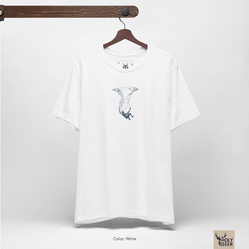 Lifestyle photograph of the deep ocean tee against a textured dark concrete background to highlight the rich teal tone and the subtle white linework of the falling figure. This piece by HolyDeer serves as a unique gift for melancholy art lovers.