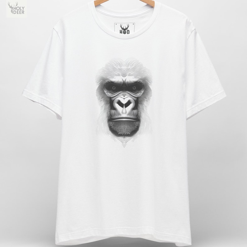 A premium gorilla graphic tee in white featuring a highly detailed optical illusion illustration of a silverback ape composed entirely of sweeping black lines, centered on the chest. This king kong t-shirt line art silhouette by HolyDeer perfectly captures the hypnotic gorilla top energy for all styles.