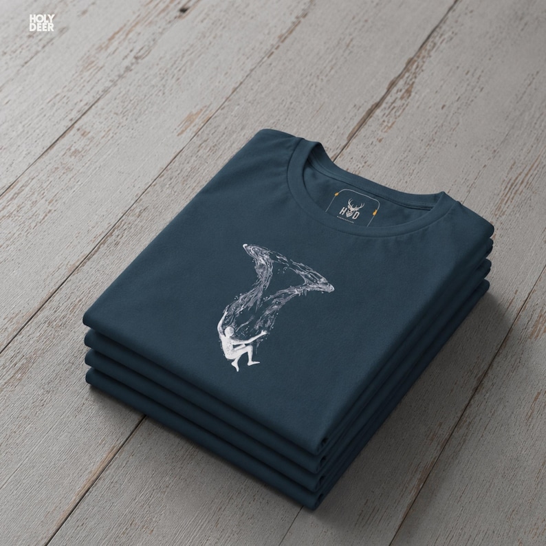 Close up detail of the deep design style graphic print on a soft deep teal fabric showcasing the fine white line work, the realistic micro bubbles, and the organic water ripples surrounding the figure. This conceptual art tee from HolyDeer is an absolute masterpiece.