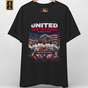 A premium United We Stand shirt in black featuring an patriotic illustration of USA soccer players, a bald eagle, and the American flag. This USA World Cup 2026 soccer tee by HolyDeer perfectly captures the USMNT pride and FIFA 2026 apparel aesthetic.