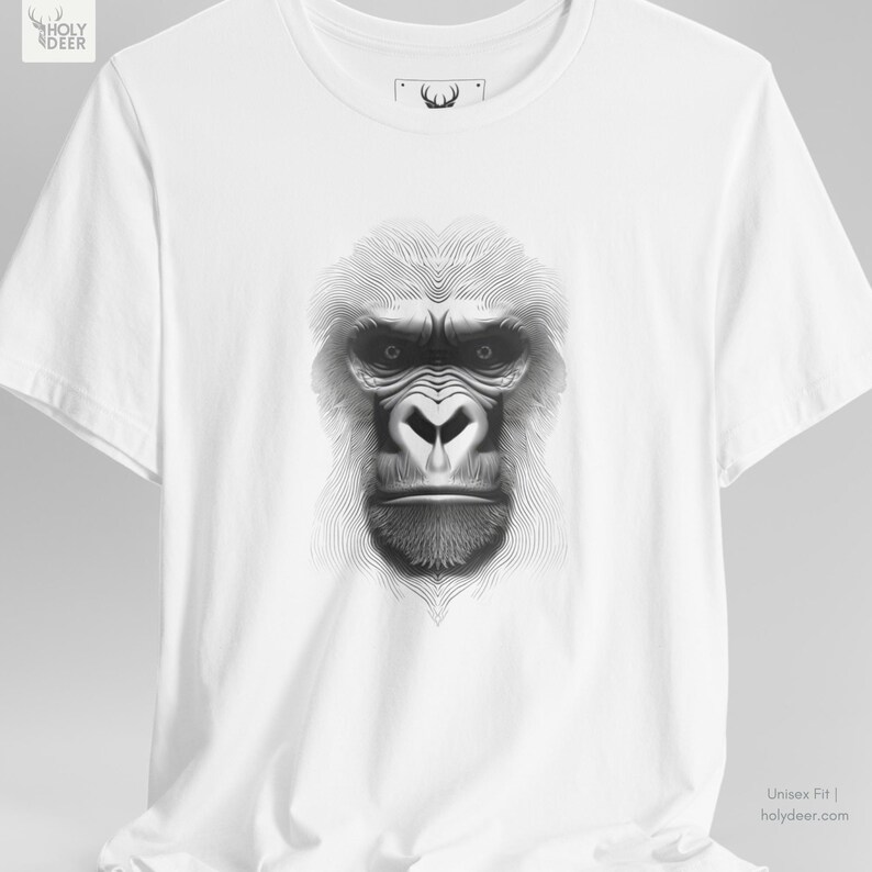Lifestyle photograph of the gorilla graphic tee against a neutral concrete backdrop to highlight the pure white cotton tone and the high-contrast linear ape graphic. This piece by HolyDeer serves as a unique gift for abstract wildlife art lovers.