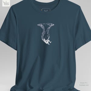 This surreal drowning top apparel in deep teal presents a professional and poetic look for freedivers, ocean lovers, and minimal graphic art collectors. HolyDeer emphasizes profound existential identity in this aesthetic teal shirt that fits perfectly in a modern wardrobe.